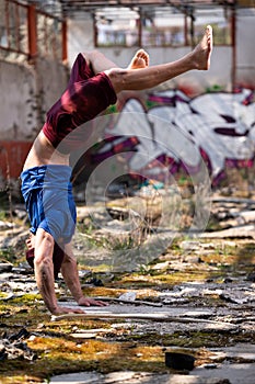 Bodyweight Training Man Standing on Hands in Warehouse