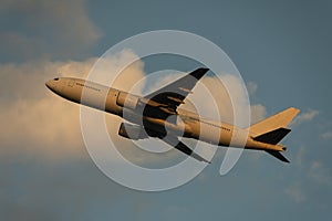 Boeing 777-200 taking off at dusk