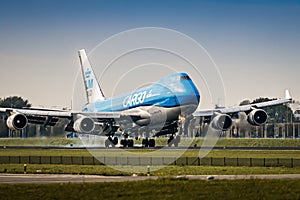 Boeing 747 landing. Touchdown on the runway with smoke from the wheels. Big cargo airplane landing.