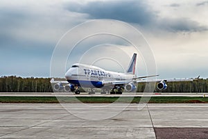 Boeing 747-400 Transaero Airlines is taxing the runway at the airport