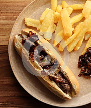 Boerewors roll with chips and braised onion