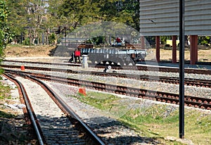 The bogie low-sided wagon is parked in the railway yard of the urban station