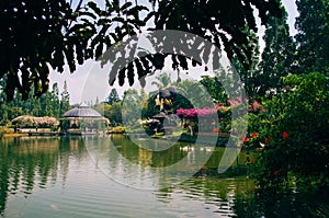 Bogor, Indonesia - A view of the flower themed park Taman Bunga Nusantara in a cloudy afternoon with a view to a green water lake