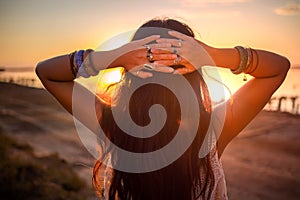 Bohemian chic gypsy happy free asian woman with manicure wearing hands jewelry accessories and white dress.