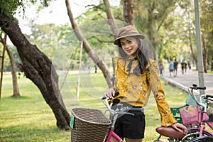 Bohemian girl with bike in summe park