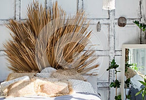 Bohemian interior bedroom with palm branches