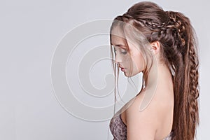 Bohemian style. Women Hairstyle with braid , romantic. Grey background. Copytext.