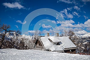 Bohinj, Slovenia - Winter view of the snowy ski hut at the top of Vogel mountain in the Alps at Triglav National Park