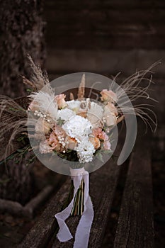 Boho bridal bouquet. White and peach wedding bouquet.