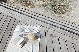 Boho eco styled beach essentials on sand by sea