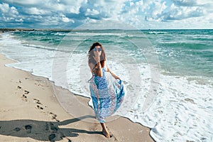 Boho girl walking on the beach