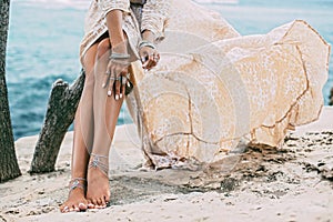 Boho girl wearing indian silver jewelry on the beach