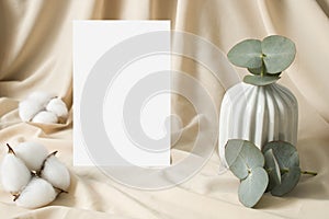 Boho invitation mockup with cotton and eucalyptus leaves