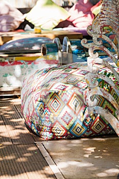 Boho style colorful poufs in garden outdoor decor photo