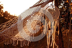 Boho style, hammock in spikelet background at sunset. Lightness and simplicity.