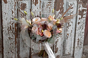 Boho style wedding bouquet with roses, dry flowers and eucalypthus