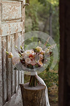 Boho style wedding bouquet with roses, dry flowers and eucalypthus.