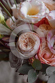 Boho style wedding bouquet with roses, dry flowers and eucalypthus.