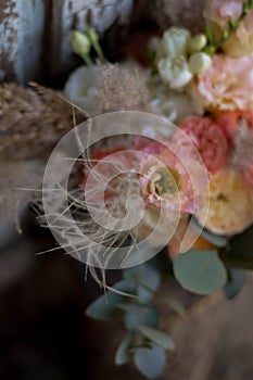 Boho style wedding bouquet with roses, dry flowers and eucalypthus.