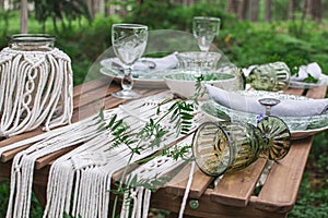 Boho style wedding reception dinning table with macrame tablecloth