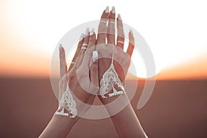 Boho style white hand tattoo. Bohemian woman carefree at the sunset, outddoor photo