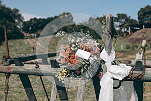 Boho summer wedding still life composition. Colorful floral bouquet with chrysathemum and eucalyptus flowers.Gift tag