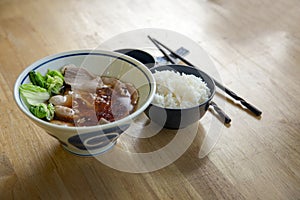 Boild pork surve with rice and soup in bowl