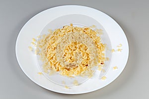 Boiled alphabet pasta on white dish on a gray background