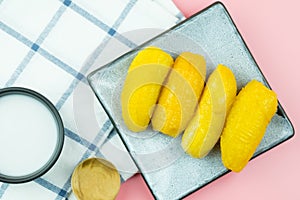 Boiled banana in syrup and wholes of banana with coconut milk