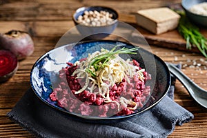 Boiled beetroot dumplings topped with hummus, smoked tofu and chives