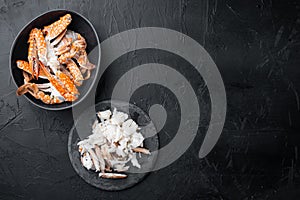 Boiled blue swimming crab claws, on black background, top view flat lay  , with copyspace  and space for text