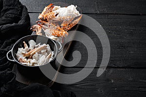 Boiled blue swimming crab claws, on black wooden table background  , with copyspace  and space for text