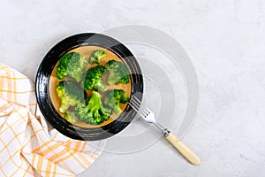 Boiled broccoli on a plate on a light background. Healthy eating concept. Sports diet. Proper nutrition. Healthy lifestyle. Free