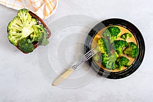 Boiled broccoli on a plate on a light background. Healthy eating concept. Sports diet. Proper nutrition. Healthy lifestyle. Free