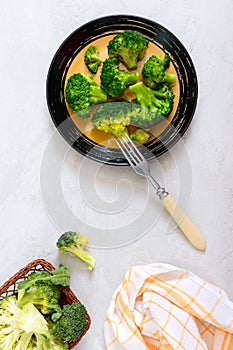 Boiled broccoli on a plate on a light background. Healthy eating concept. Sports diet. Proper nutrition. Healthy lifestyle. Free