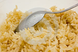 Boiled brown rice and a spoon