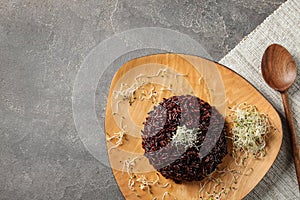 Boiled brown rice with sprouted flax seeds served on table, flat lay