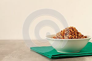 Boiled buckwheat in a plate on a stone table