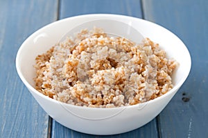 Boiled cereals in bowl on blue background