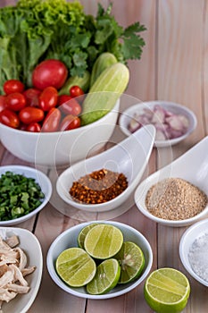 Boiled chicken cut into pieces in a white dish on a wooden table