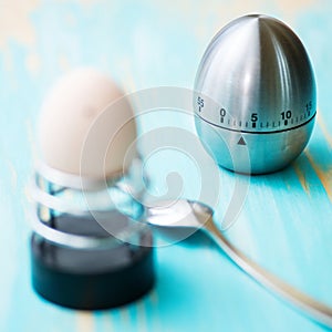 Boiled chicken egg in a metallic support