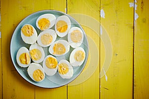 Boiled chicken eggs on a blue ceramic plate. The concept of Easter Holidays