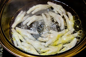 Boiled chicken legs in pot