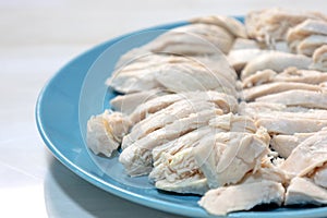 boiled chicken meat on blue plate