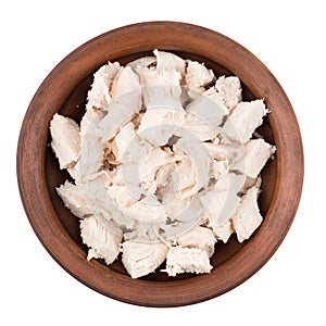Boiled chicken meat in a ceramic bowl. White isolated background