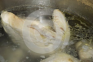 boiled chicken in a saucepan. broth for soup. food, background for decoration. cooking in the kitchen.