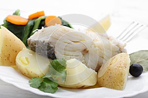 Boiled cod fish with potatoes and cole