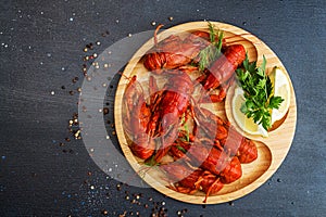 Boiled cooked crayfish crawfish ready to eat on wooden plate on