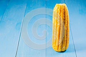 Boiled corn on a blue wooden table/Vegetarian concept. Boiled corn on a blue wooden table. Copy space