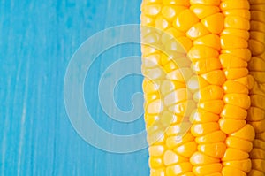 Boiled corn on a blue wooden table/Vegetarian concept. Close up. Boiled corn on a blue wooden table. Copy space